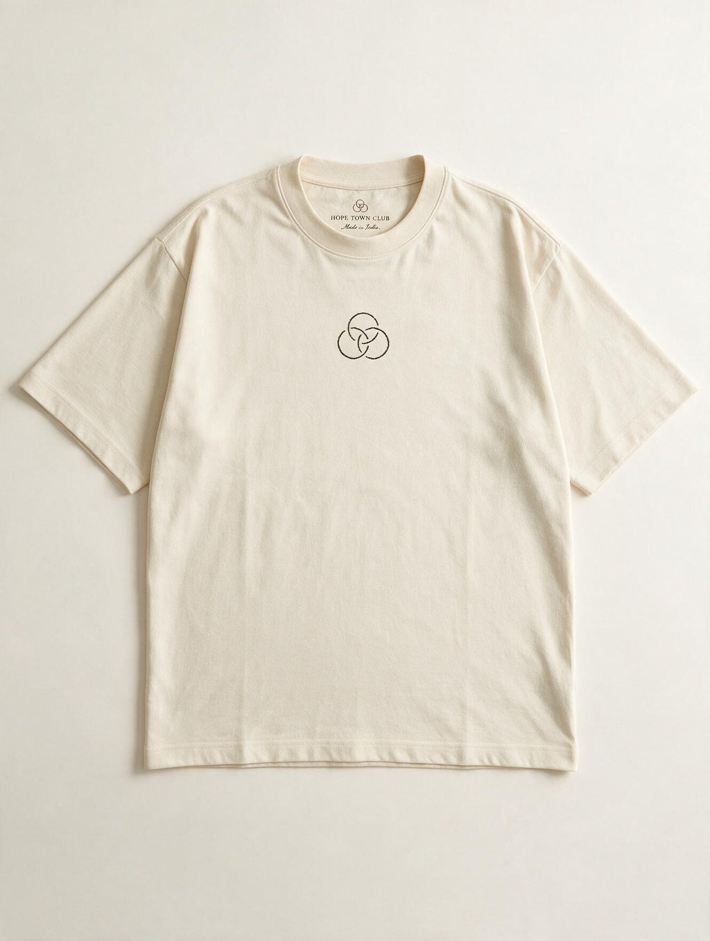Still Here Off White - Product flat lay with neck label