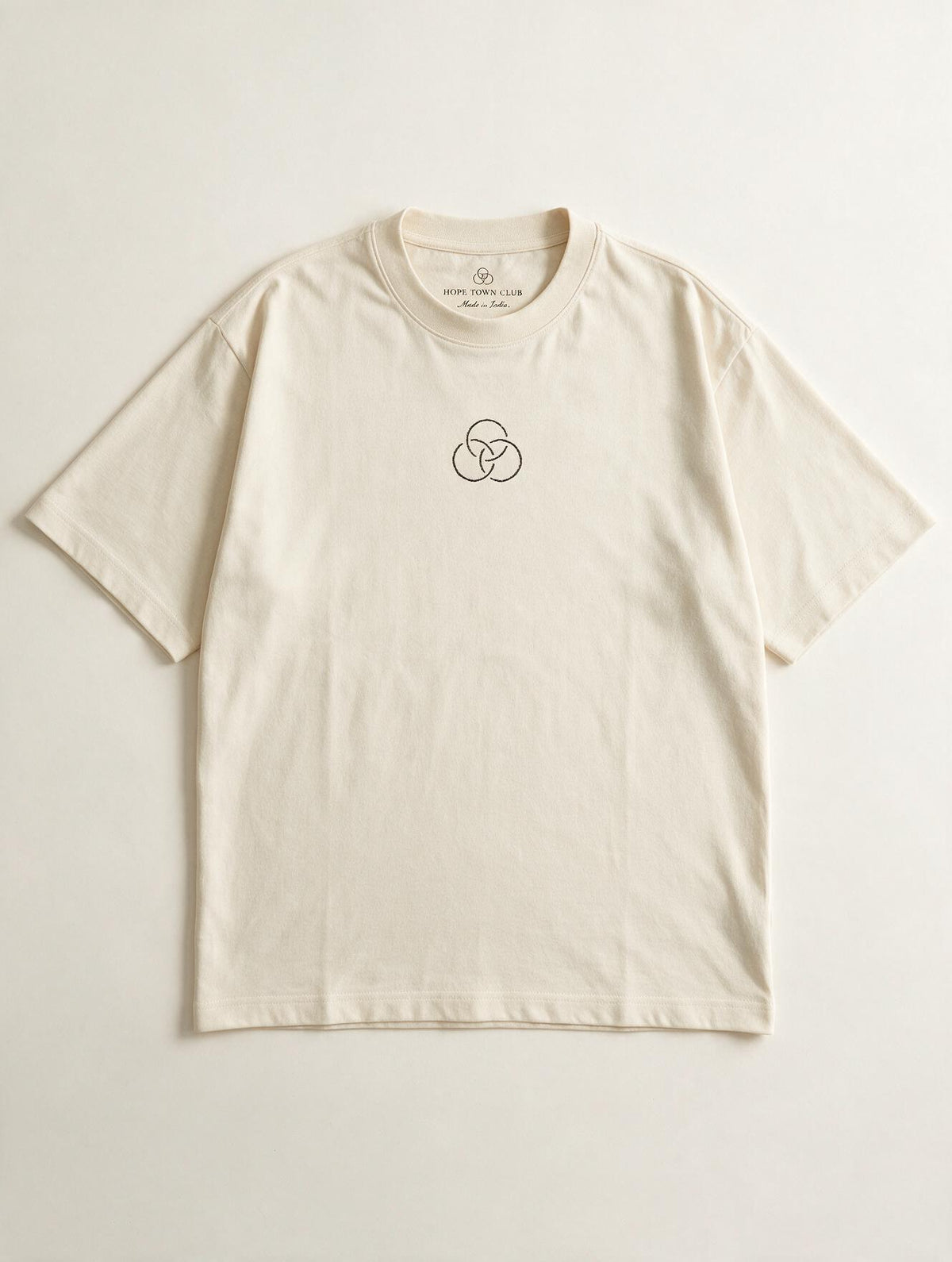 Still Here Off White - Product flat lay with neck label